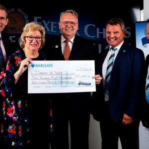 Photo of DAW Chairman Jeff Merrett MBE and management committee team member Paula Stacey at the awards ceremony at the home of the Chiefs receiving a cheque for £5859.43 from rugby legend Phil Vickery MBE